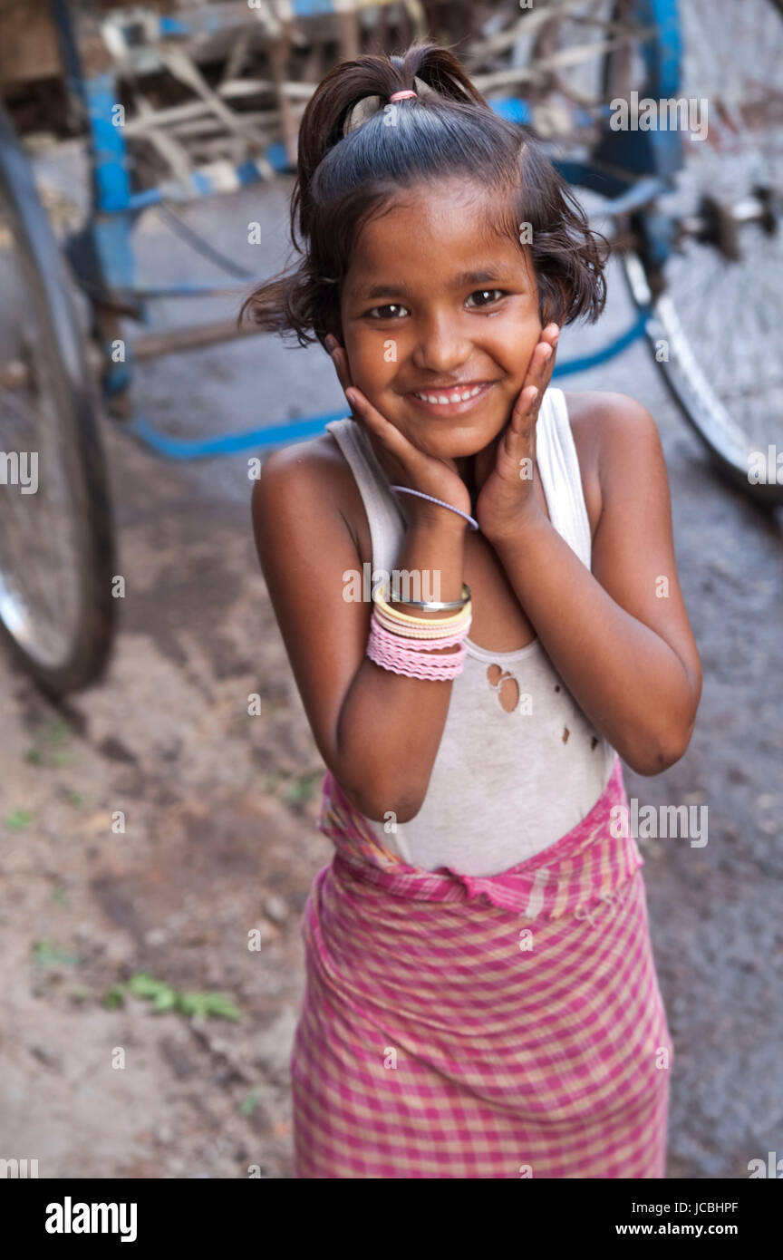 Smiling girl from a poor family in a street in Old Delhi, India Stock ...