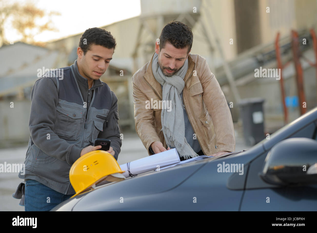 male architects discussing outside industry Stock Photo