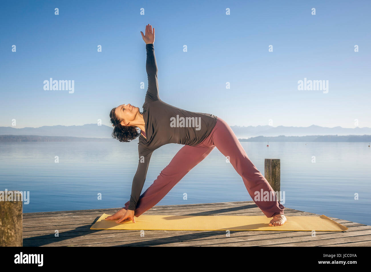An image of a pretty woman doing yoga at the lake Stock Photo - Alamy