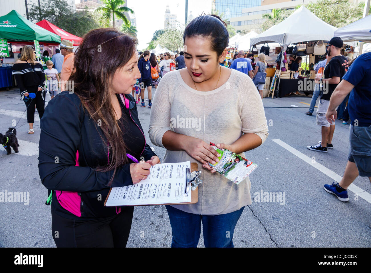 Florida Coral Gables,Miami,Carnaval Miami,carnival,street festival,Latin cultural celebration,survey taking,Hispanic woman female women,clipboard,FL17 Stock Photo