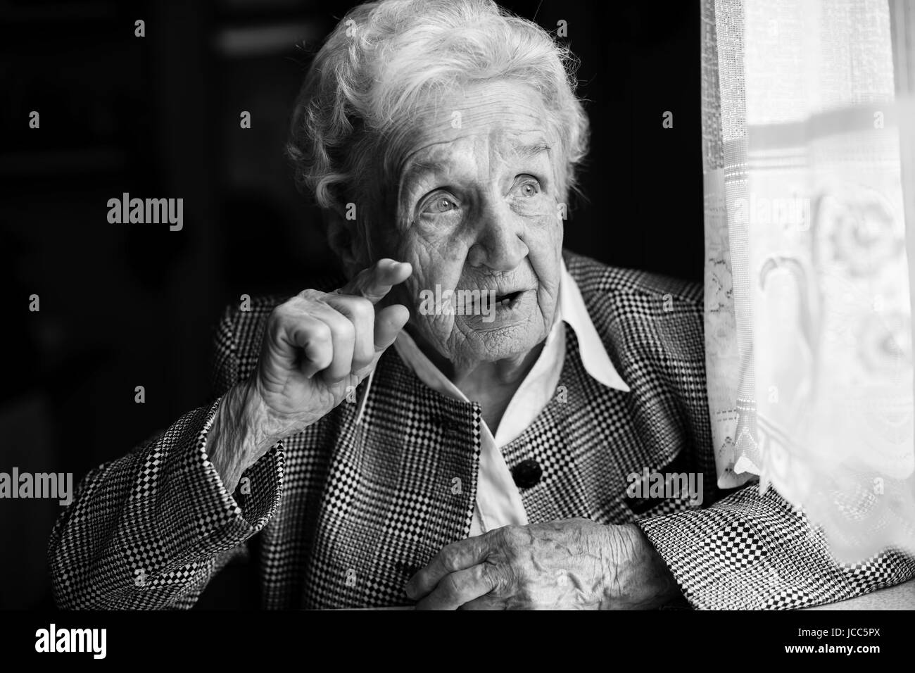 Portrait of an elderly women emotionally. Black-and-white photo. Stock Photo