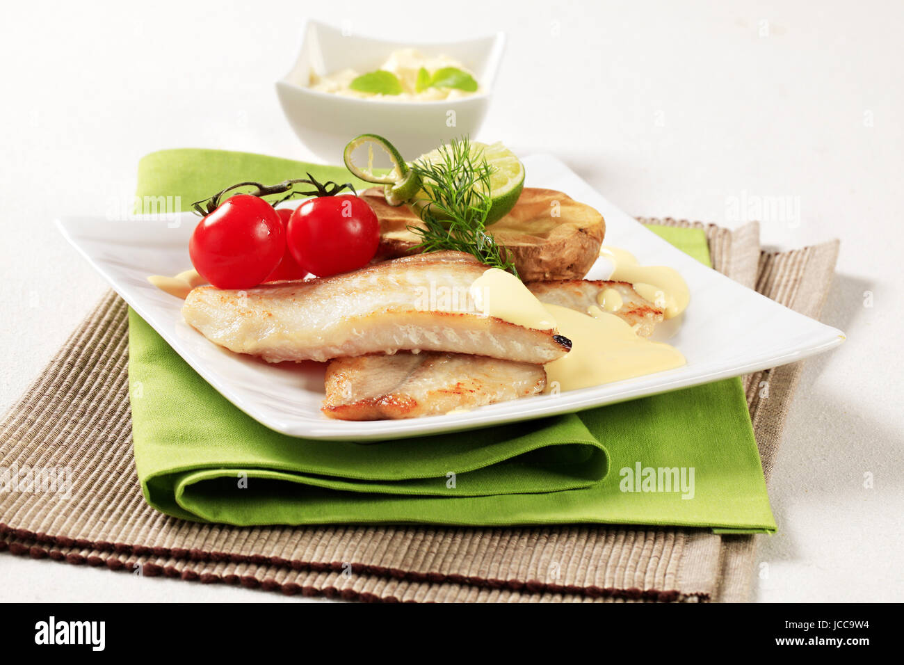 Pan fried fish fillets with roasted potato Stock Photo