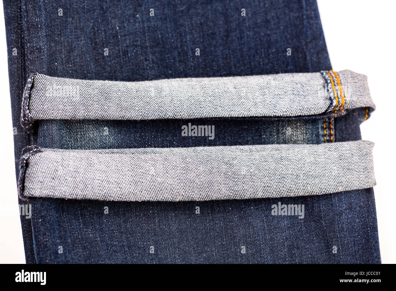 Denim blue jeans folded hemmed close up on with background Stock Photo