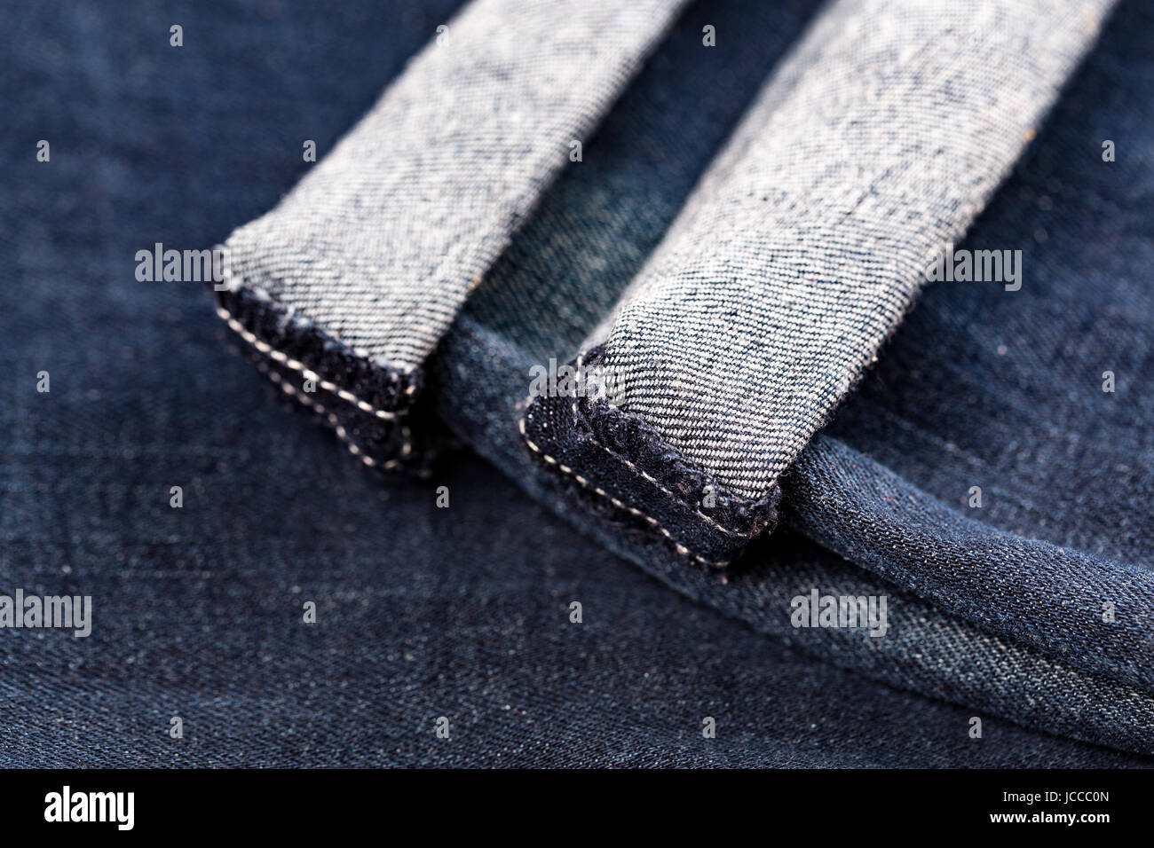 Denim blue jeans folded hemmed close up on with background Stock Photo