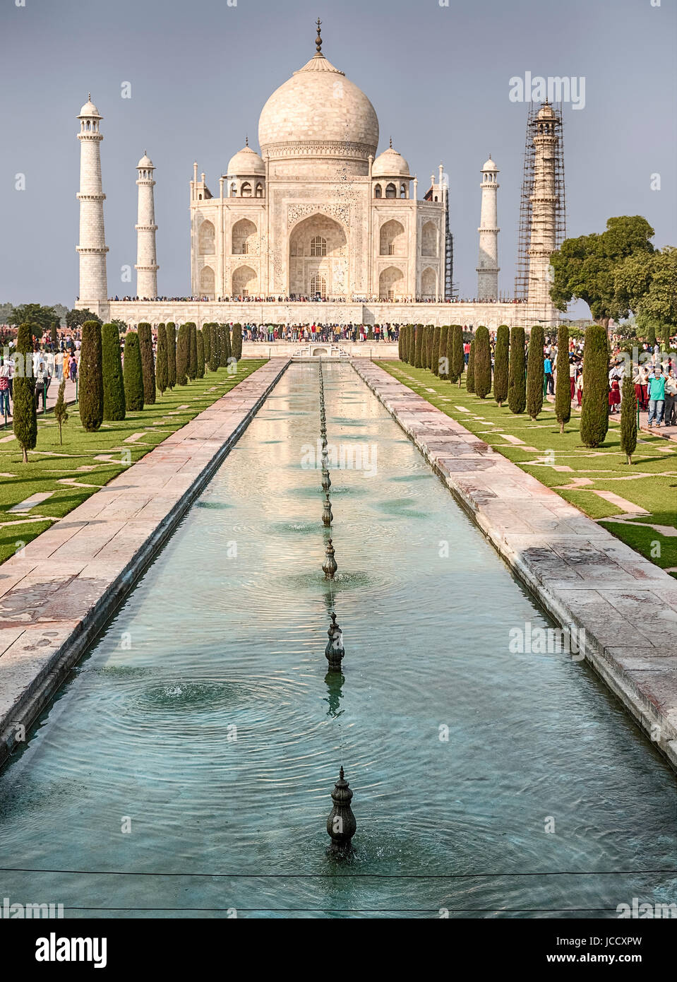 The main facade of the Taj Mahal in Agra, India is located at the end of a long reflecting pool. The memorial, including the four minarets at the corn Stock Photo