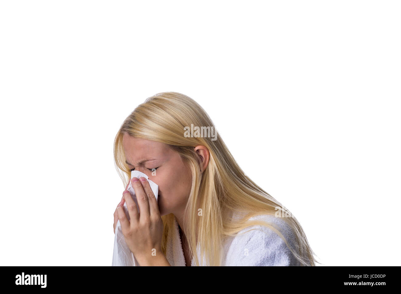 Blondine niest in ein Taschentuch Stock Photo
