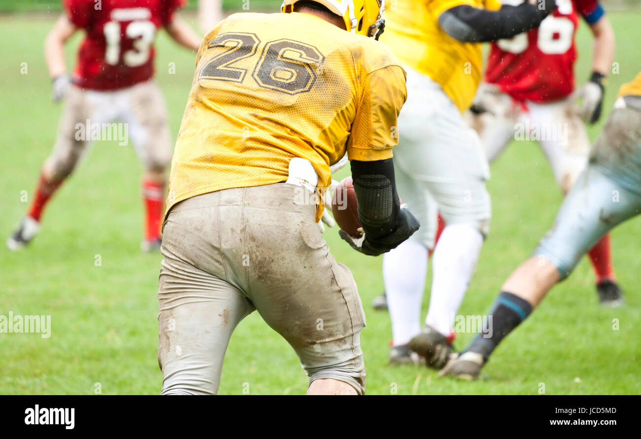 American football game in rain Stock Photo Alamy