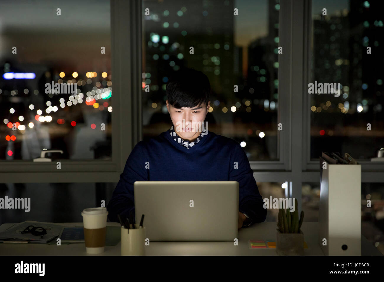 Businessman working overtime at night Stock Photo