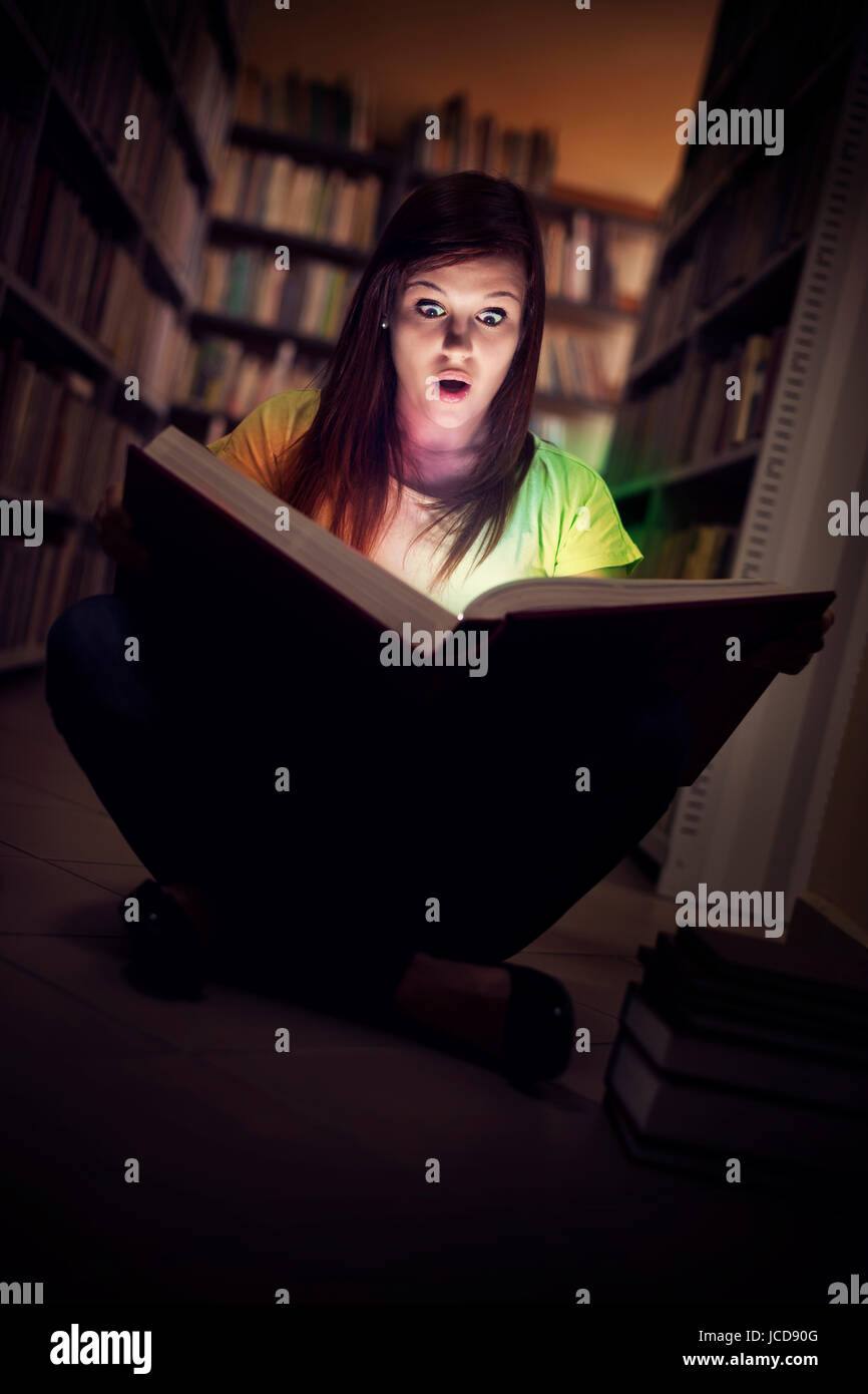 Woman shock reading book library hi-res stock photography and images ...
