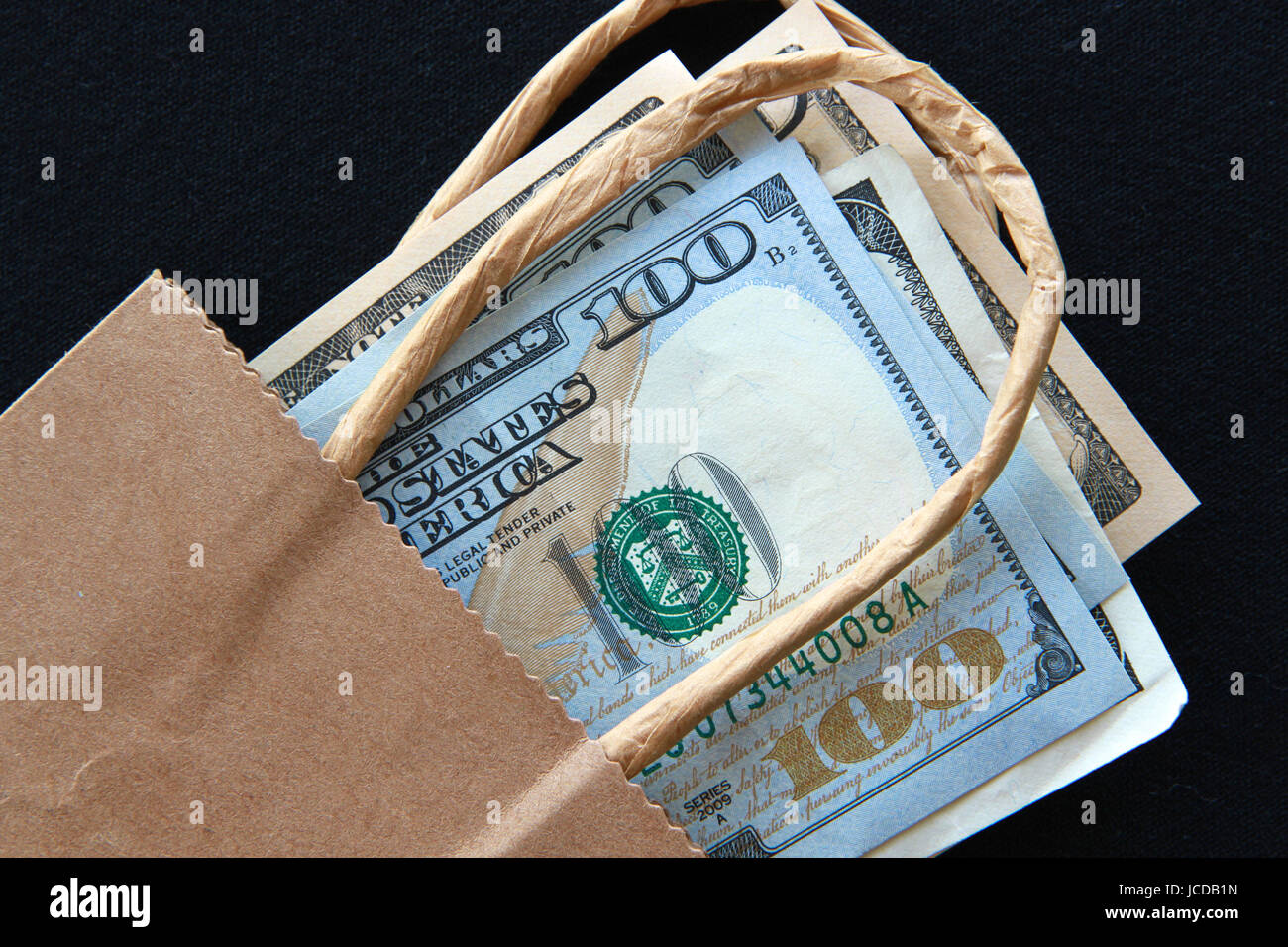 American dollars in a brown paper bag Stock Photo Alamy