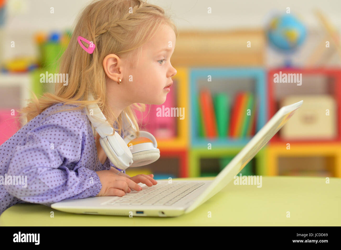 Portrait of adorable little girl using modern laptop Stock Photo - Alamy