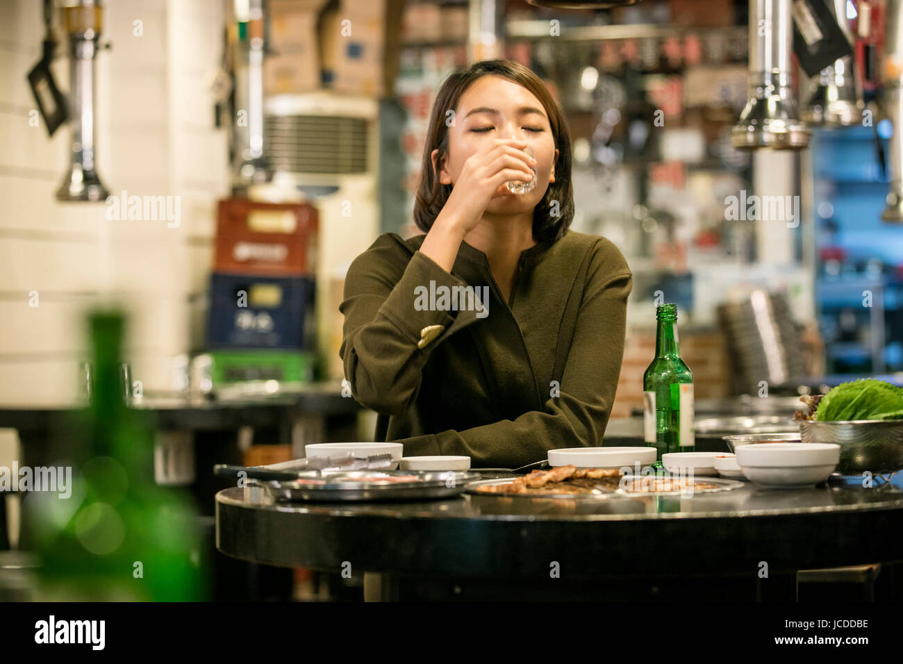 Portrait of single woman drinking alone at restaurant Stock Photo