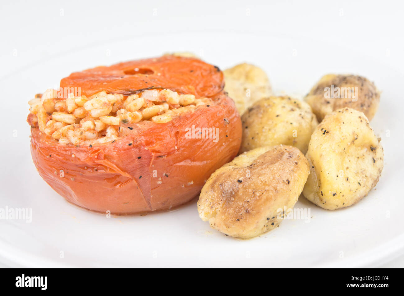 Rice stuffed tomatoes with potatoes Stock Photo