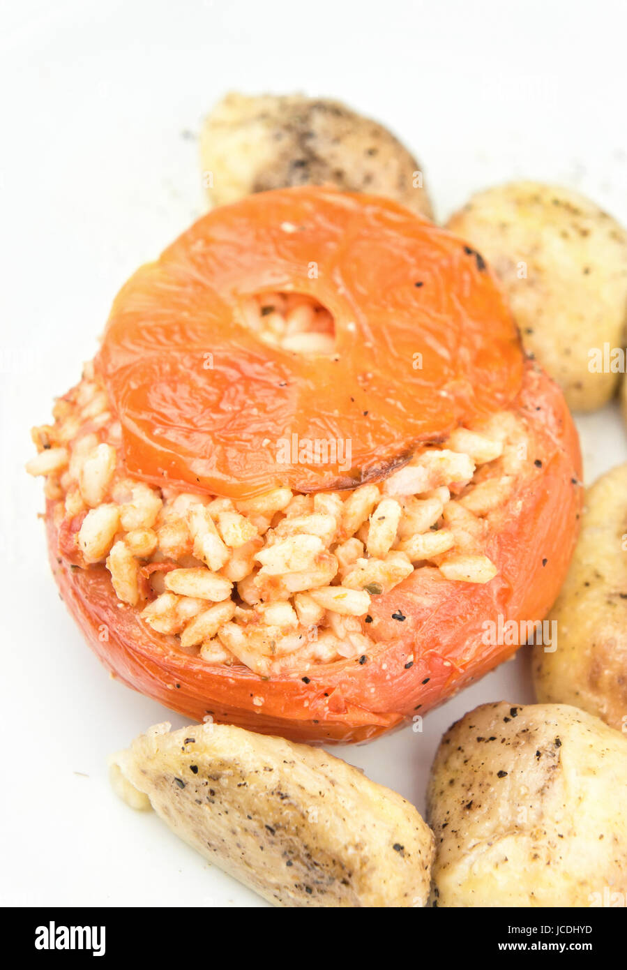 Rice stuffed tomatoes with potatoes Stock Photo