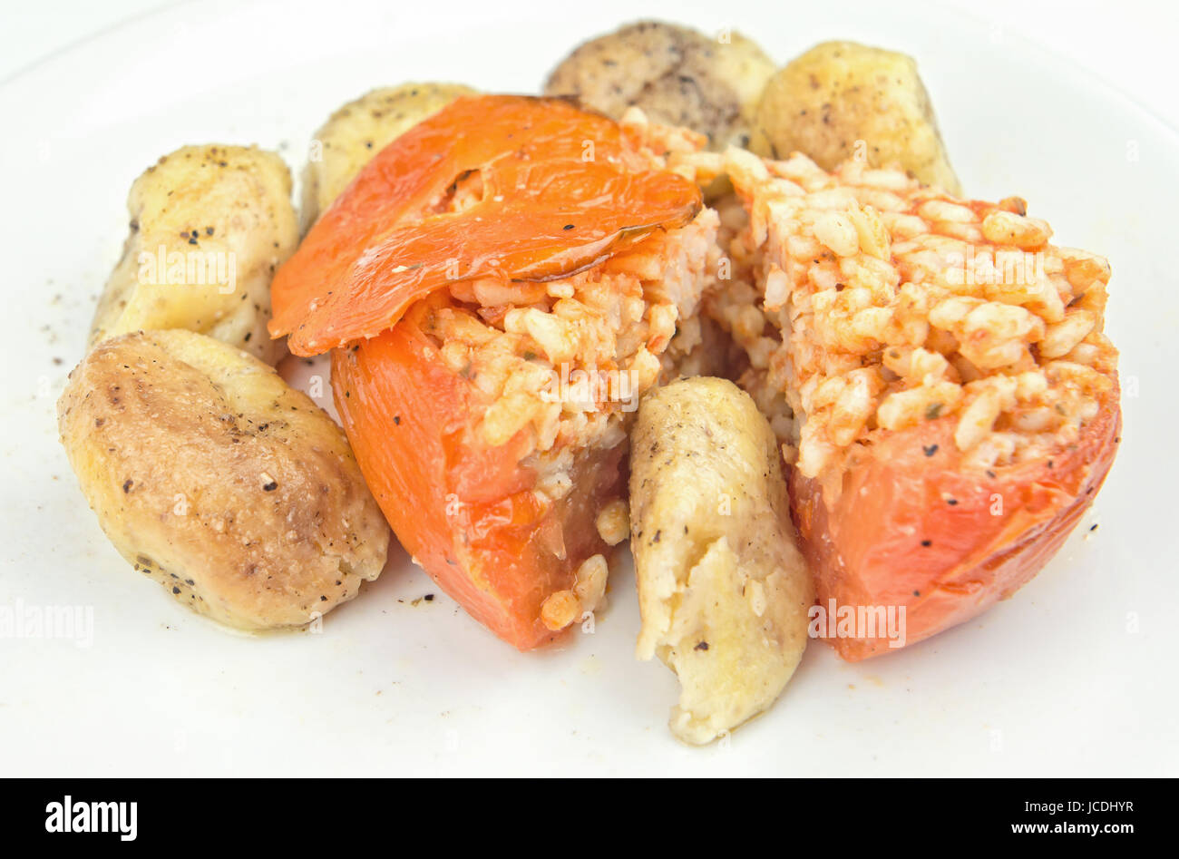 Rice stuffed tomatoes with potatoes Stock Photo