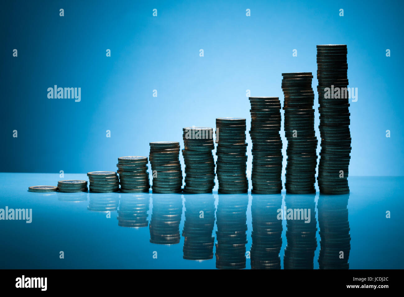 Stack Of One Euro Coins Over Blue Background Stock Photo - Alamy