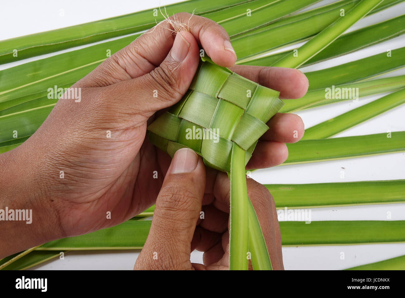 Making of Ketupat, a natural rice casing made from young coconut leaves ...