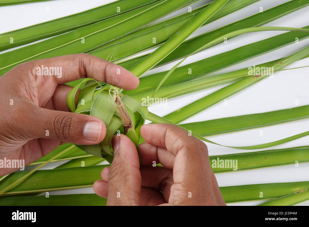 Making of Ketupat, a natural rice casing made from young coconut leaves ...