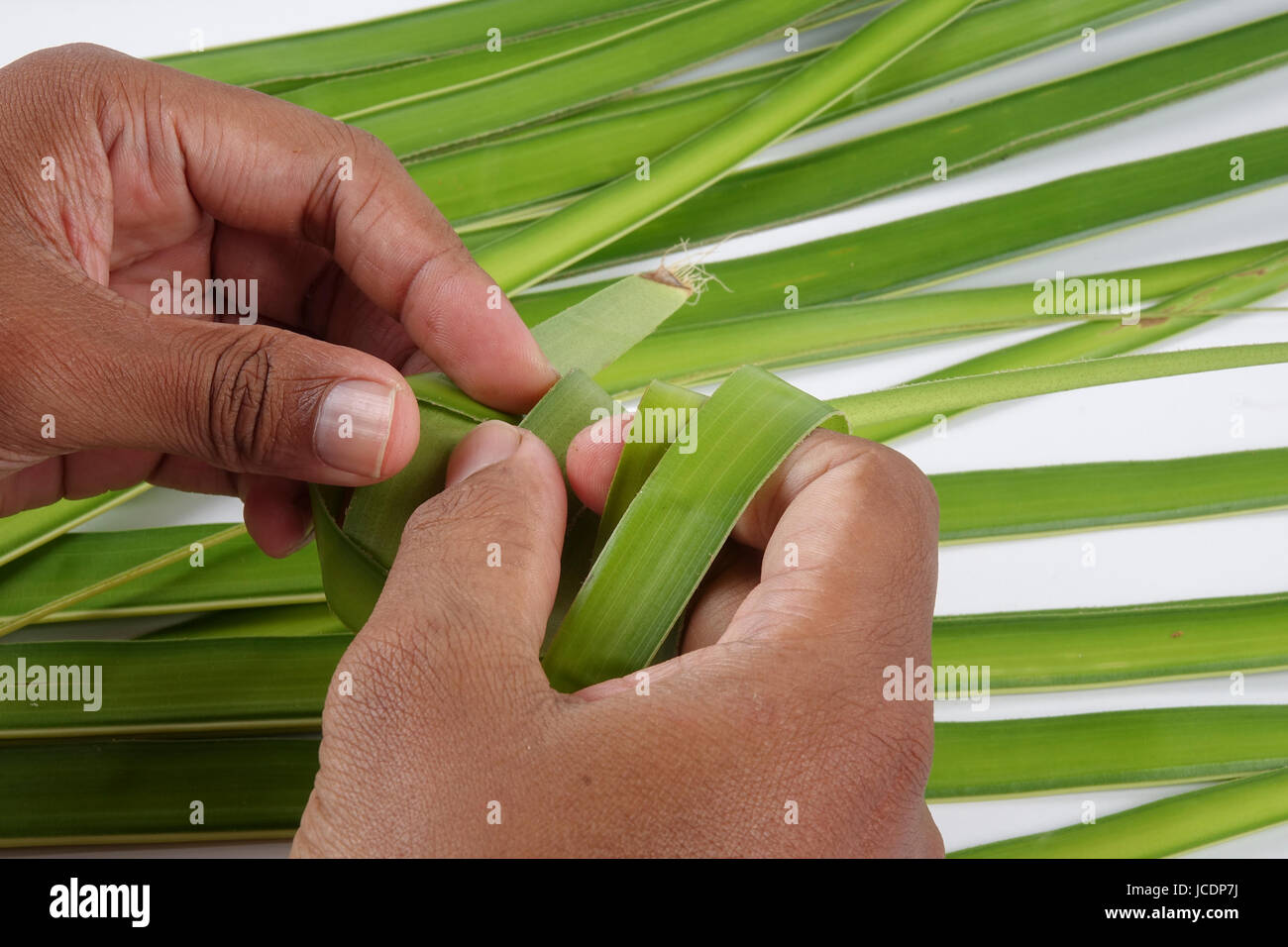 Making of Ketupat, a natural rice casing made from young coconut leaves ...