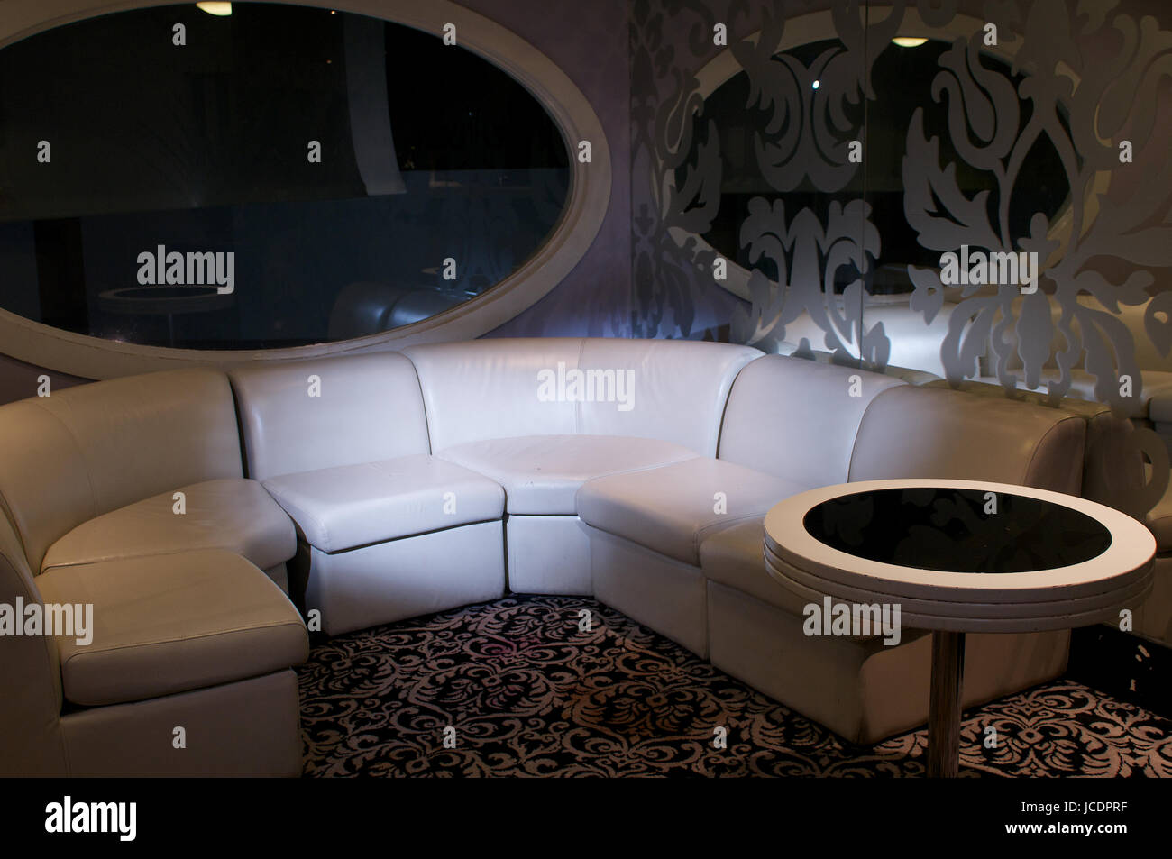 Interior of a night club with large sofa and spotlight Stock Photo - Alamy