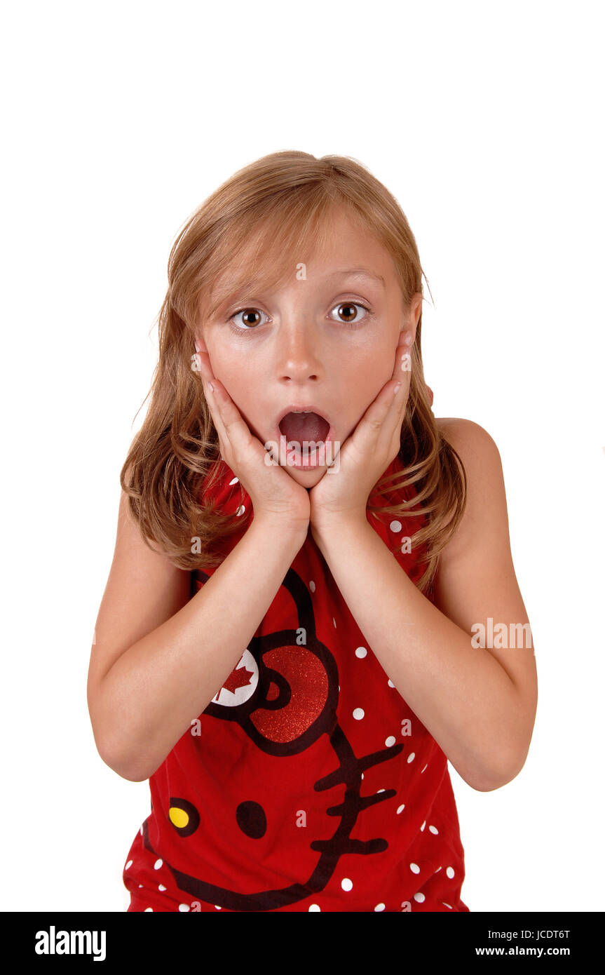A lovely young girl in a red sweater holding her hands on her face ...