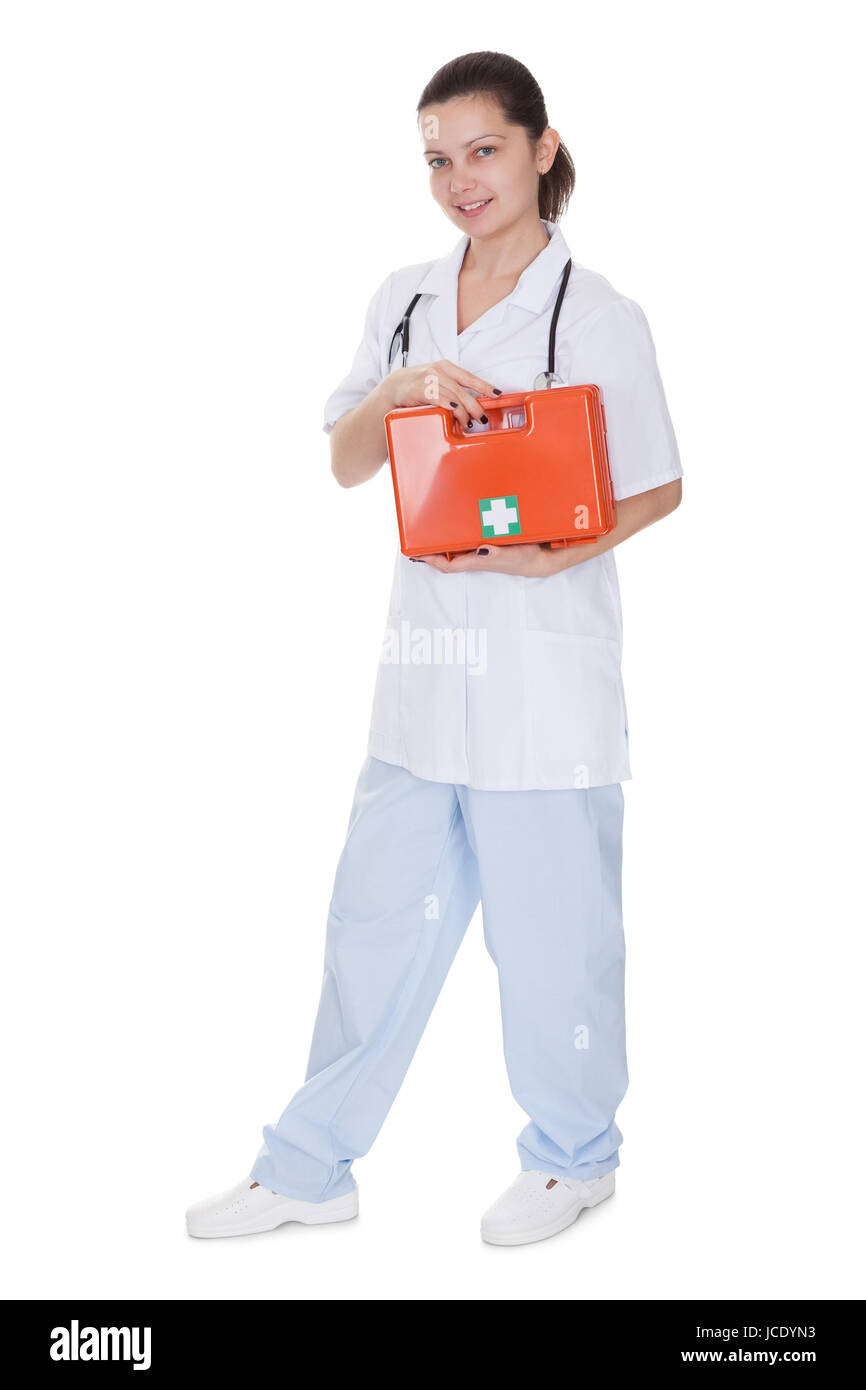 Attractive young smiling female nurse or doctor carrying a portable
