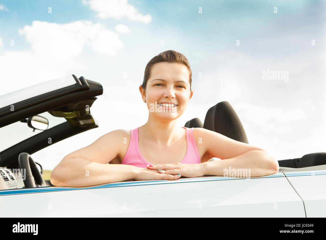 Happy Young Woman Sitting In Her Car Stock Photo - Alamy