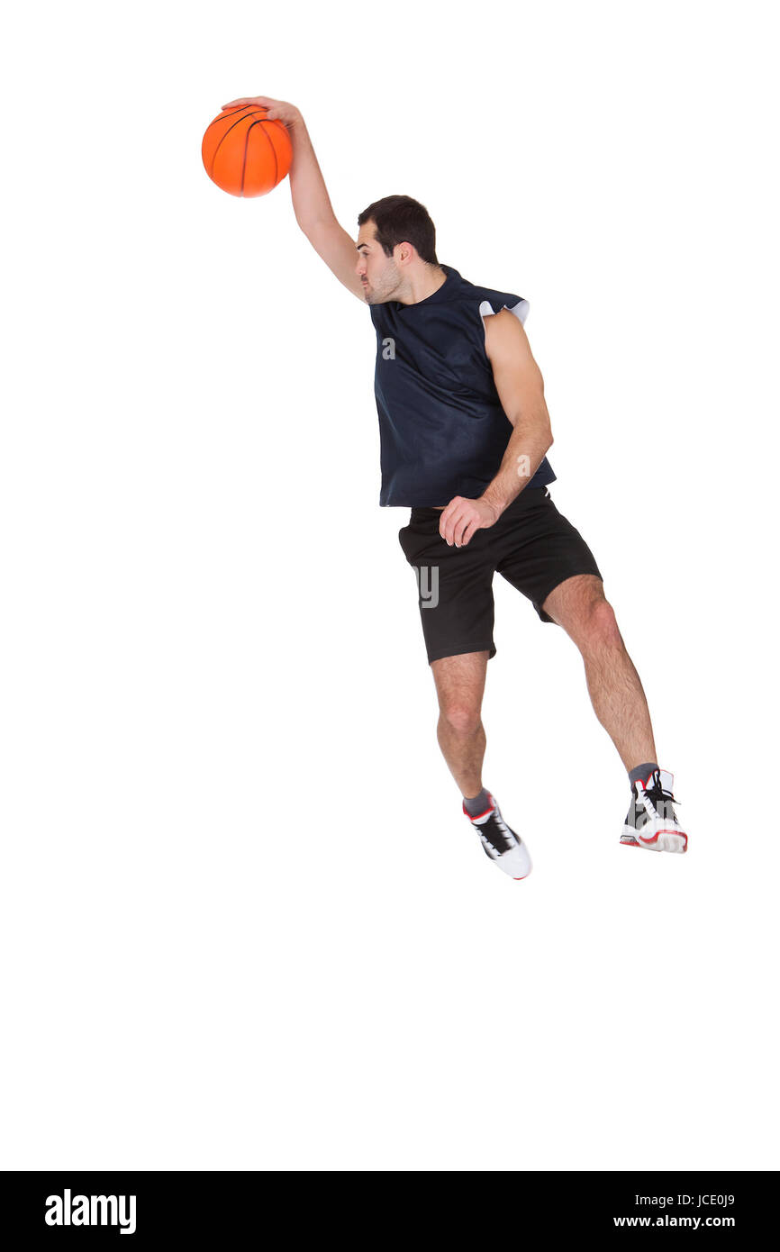 Professional basketball player throwing the ball. Isolated on white