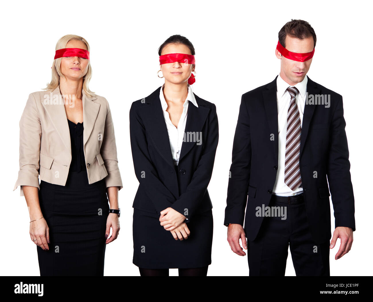 Group of disoriented businesspeople with red ribbons on eyes Stock Photo