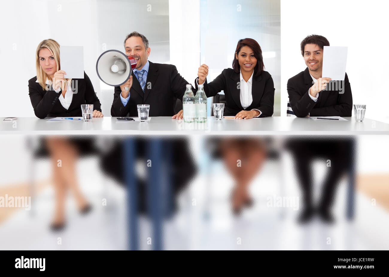 Group of panel judges holding empty score signs Stock Photo Alamy