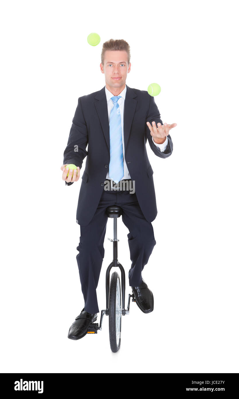 Happy Businessman Juggling Ball Sitting On Unicycle Stock Photo Alamy