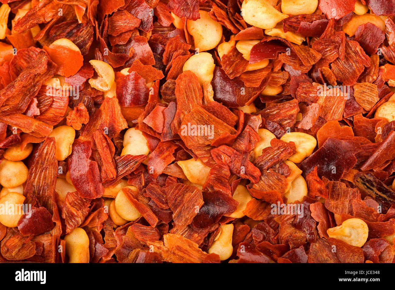 cayenne pepper flakes real time macro0 background Stock Photo Alamy