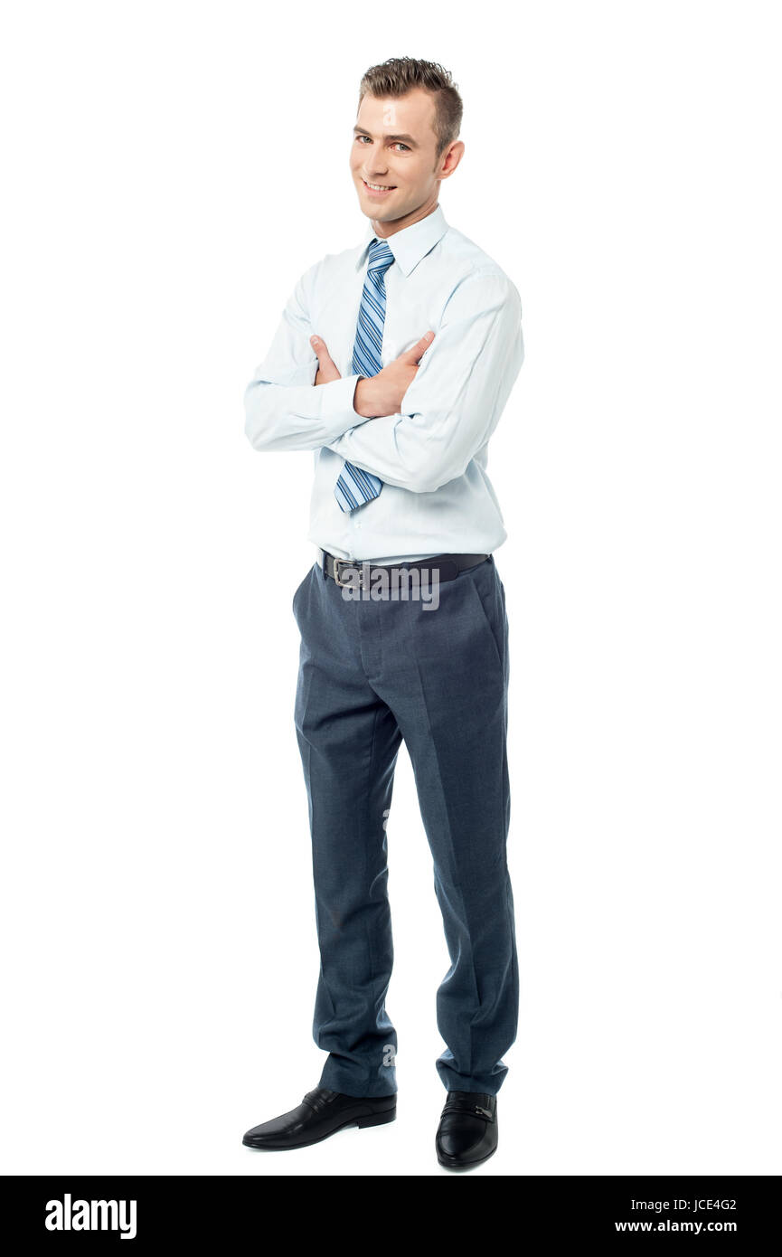 Handsome businessman standing with arms crossed Stock Photo - Alamy