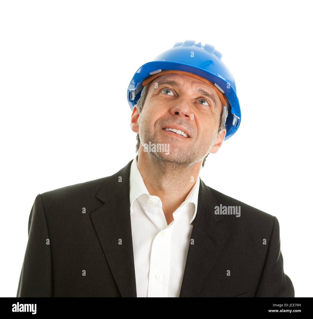 Portrait of successfull architect wearing blue hard hat and looking up