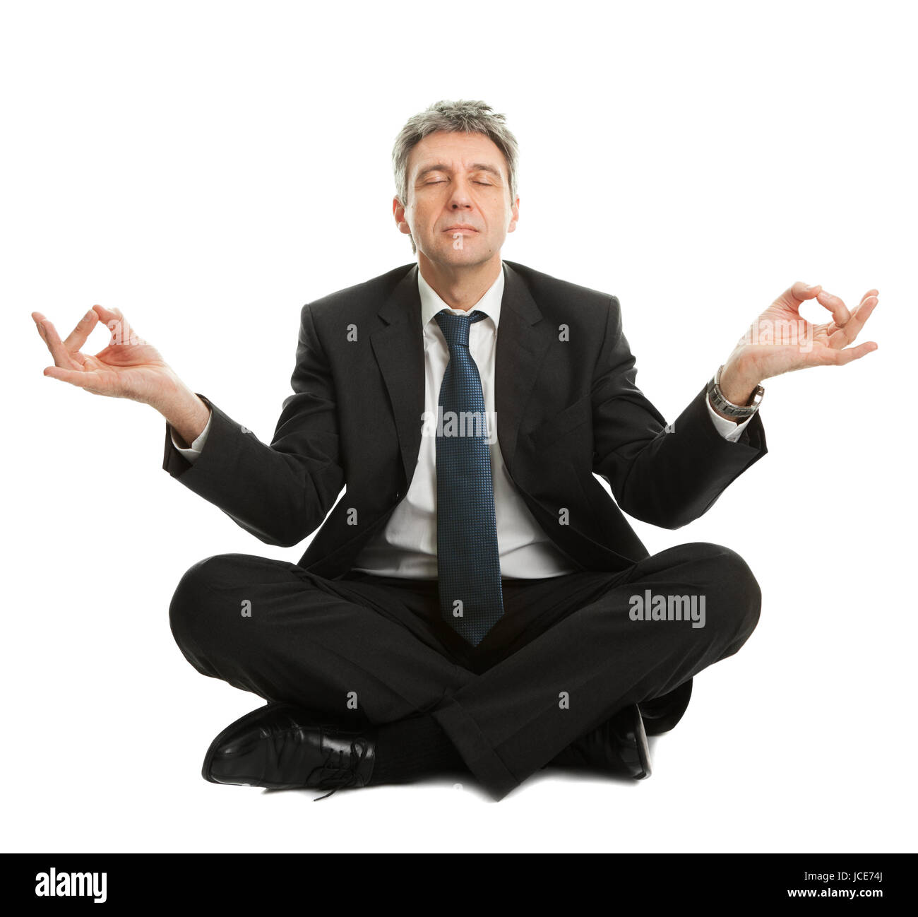 Businessman sitting in lotus flower position of yoga. Isolated on white Stock Photo Alamy