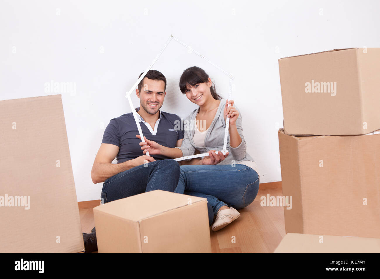 Happy young couple moving into new house Stock Photo - Alamy