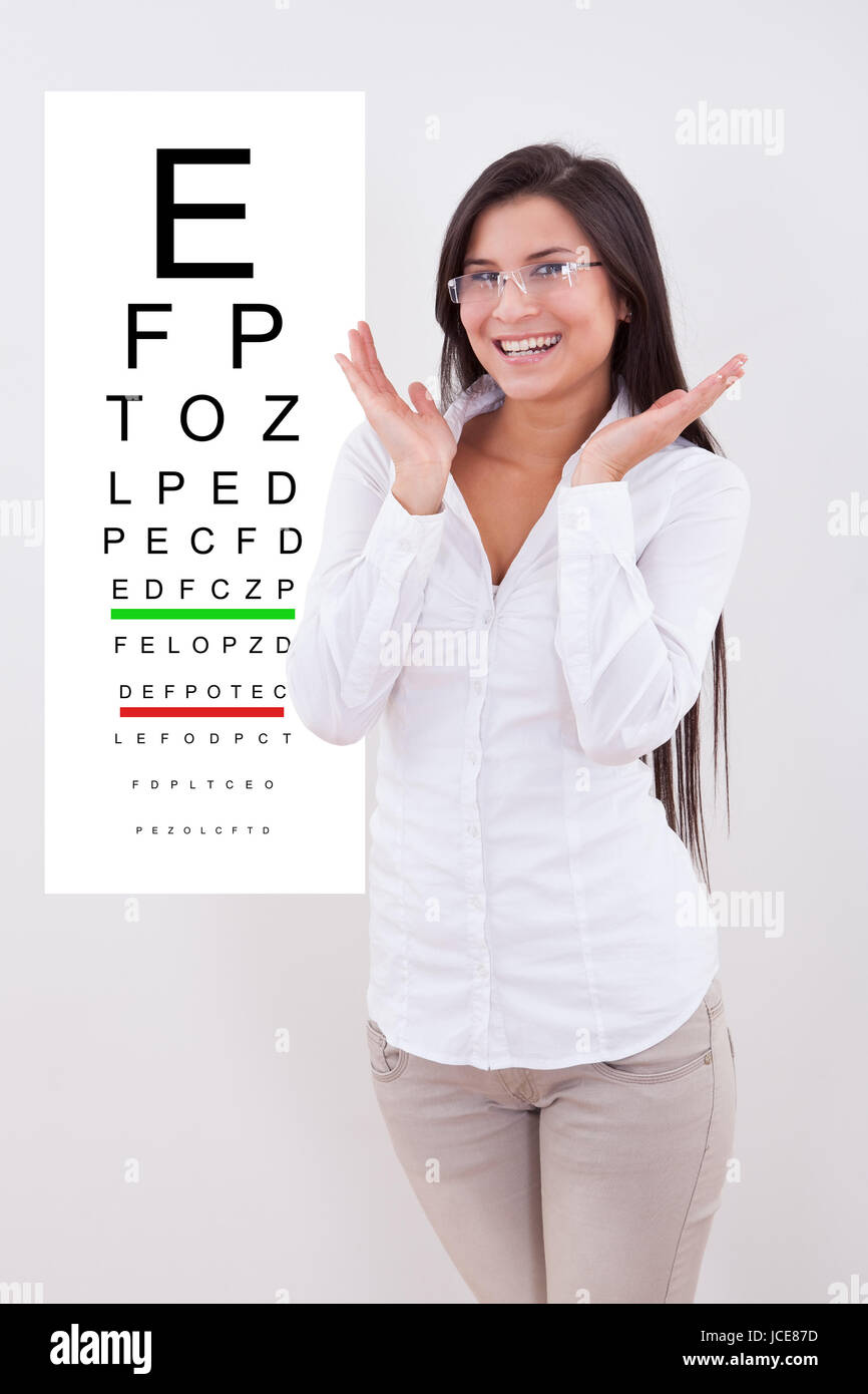https://c8.alamy.com/comp/JCE87D/jubilant-lady-with-new-glasses-standing-in-front-of-an-opticians-eye-JCE87D.jpg