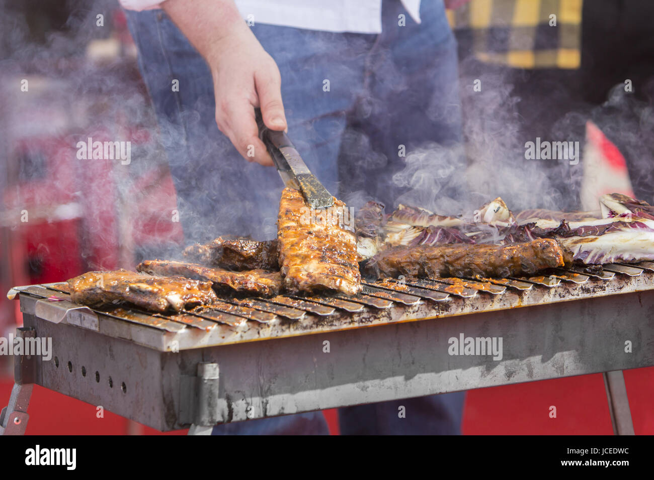 Chef bbq grilled pork ribs on smoke Stock Photo