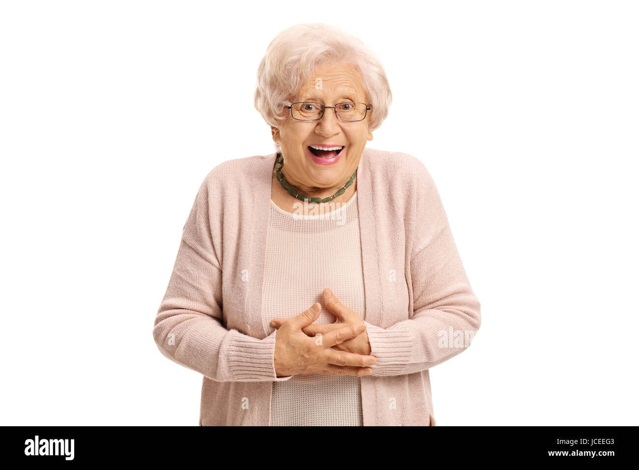 Surprised elderly woman looking at the camera and laughing isolated on  white background Stock Photo - Alamy