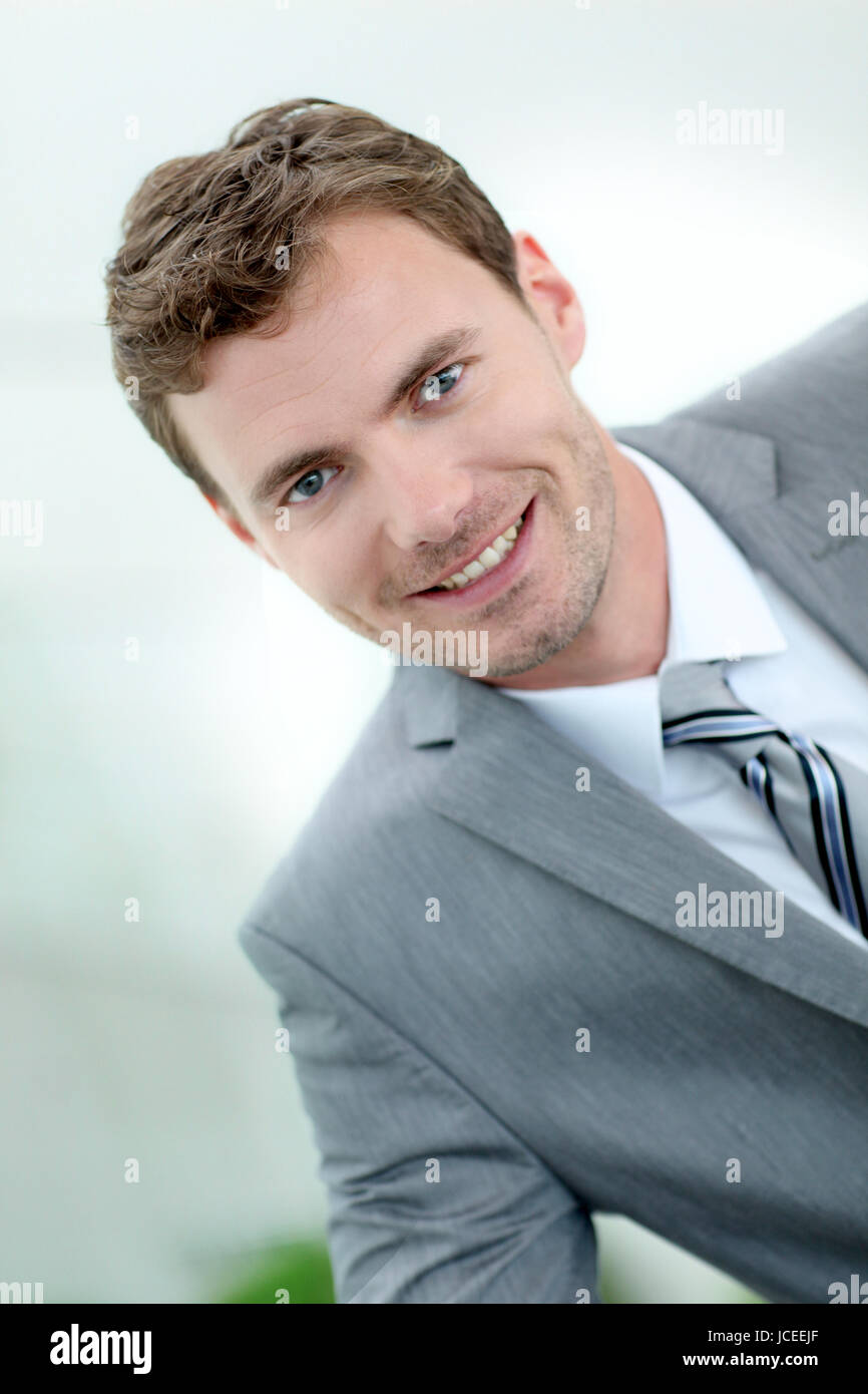 Portrait of cheerful businessman wearing grey suit Stock Photo