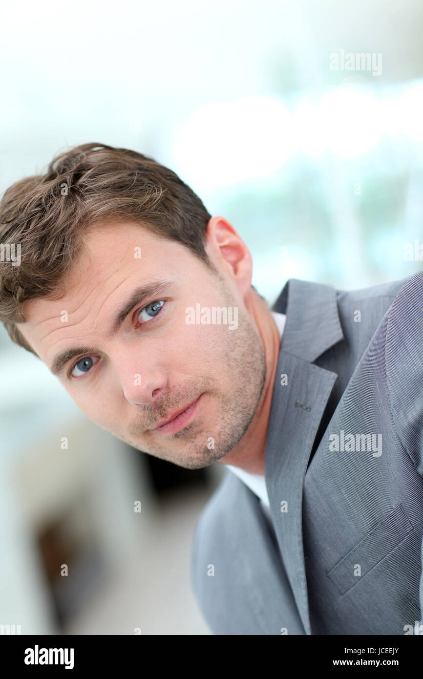 Portrait of cheerful businessman wearing grey suit Stock Photo - Alamy