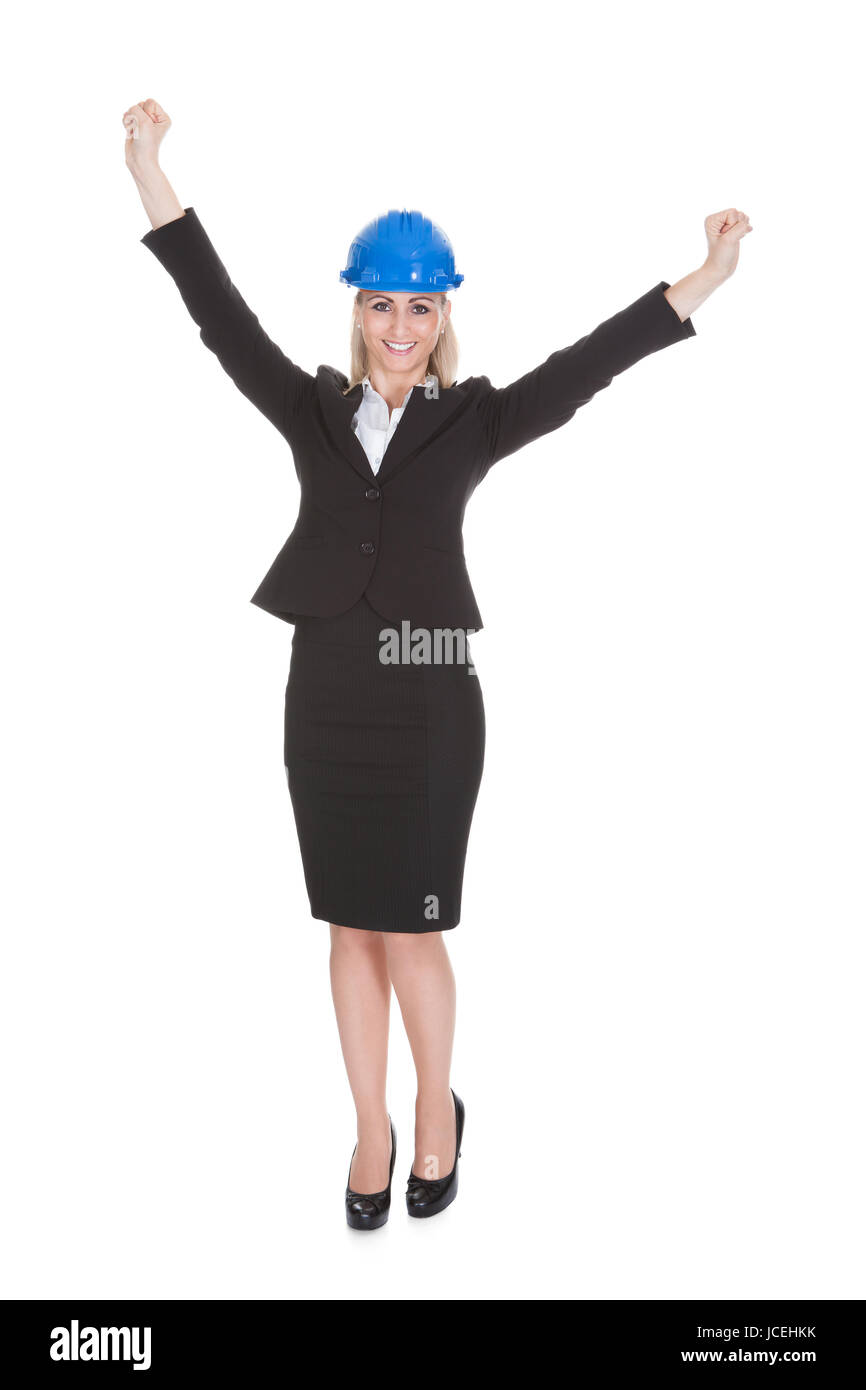 Portrait Of Excited Female Architect Holding Blueprint Over White Background Stock Photo