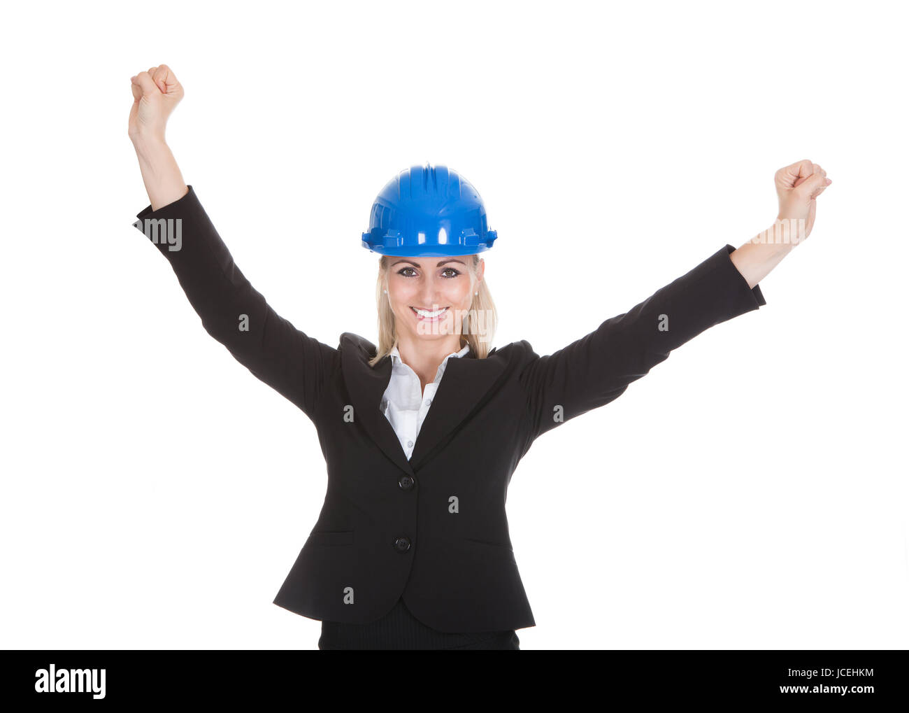 Portrait Of Excited Female Architect Holding Blueprint Over White Background Stock Photo