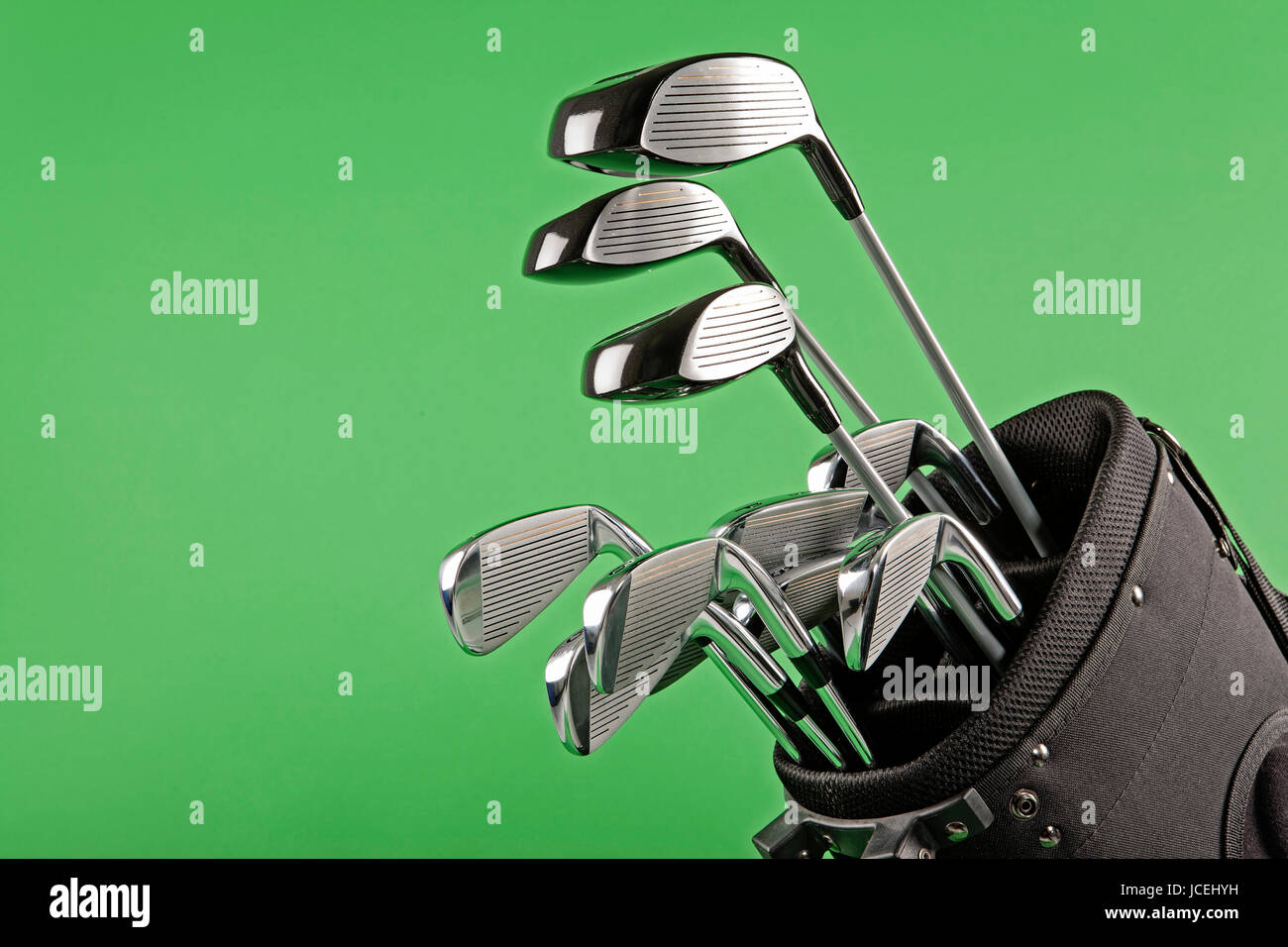 steel golf clubs on chroma green background Stock Photo Alamy