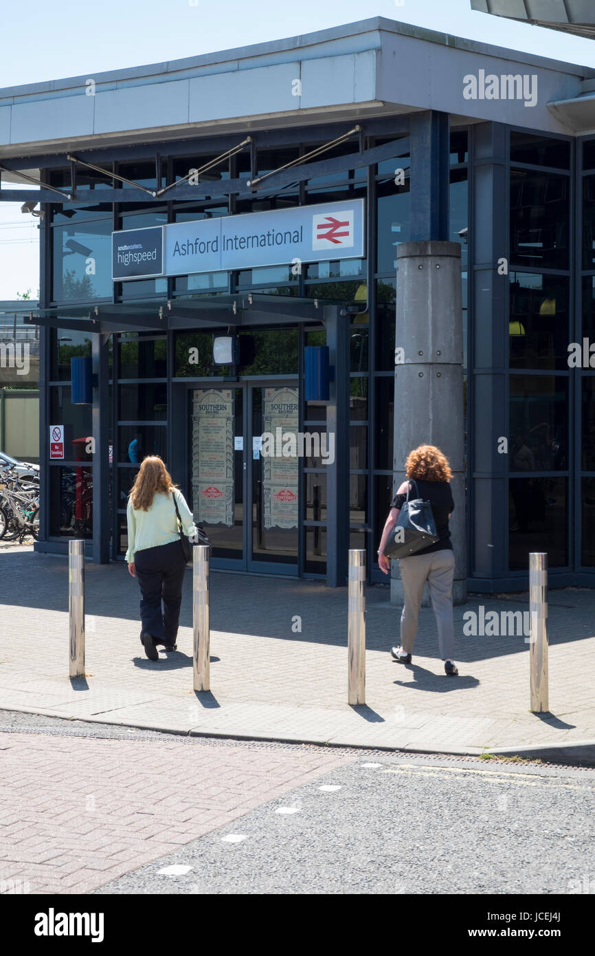 Entrance to Ashford international and southeastern highspeed train station british rail commuters women bright sunny day Stock Photo