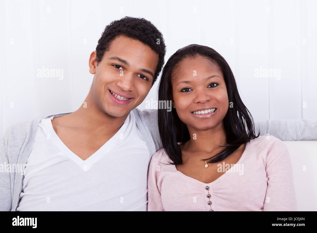 Portrait Of Happy Young Couple At Home Smiling Stock Photo - Alamy