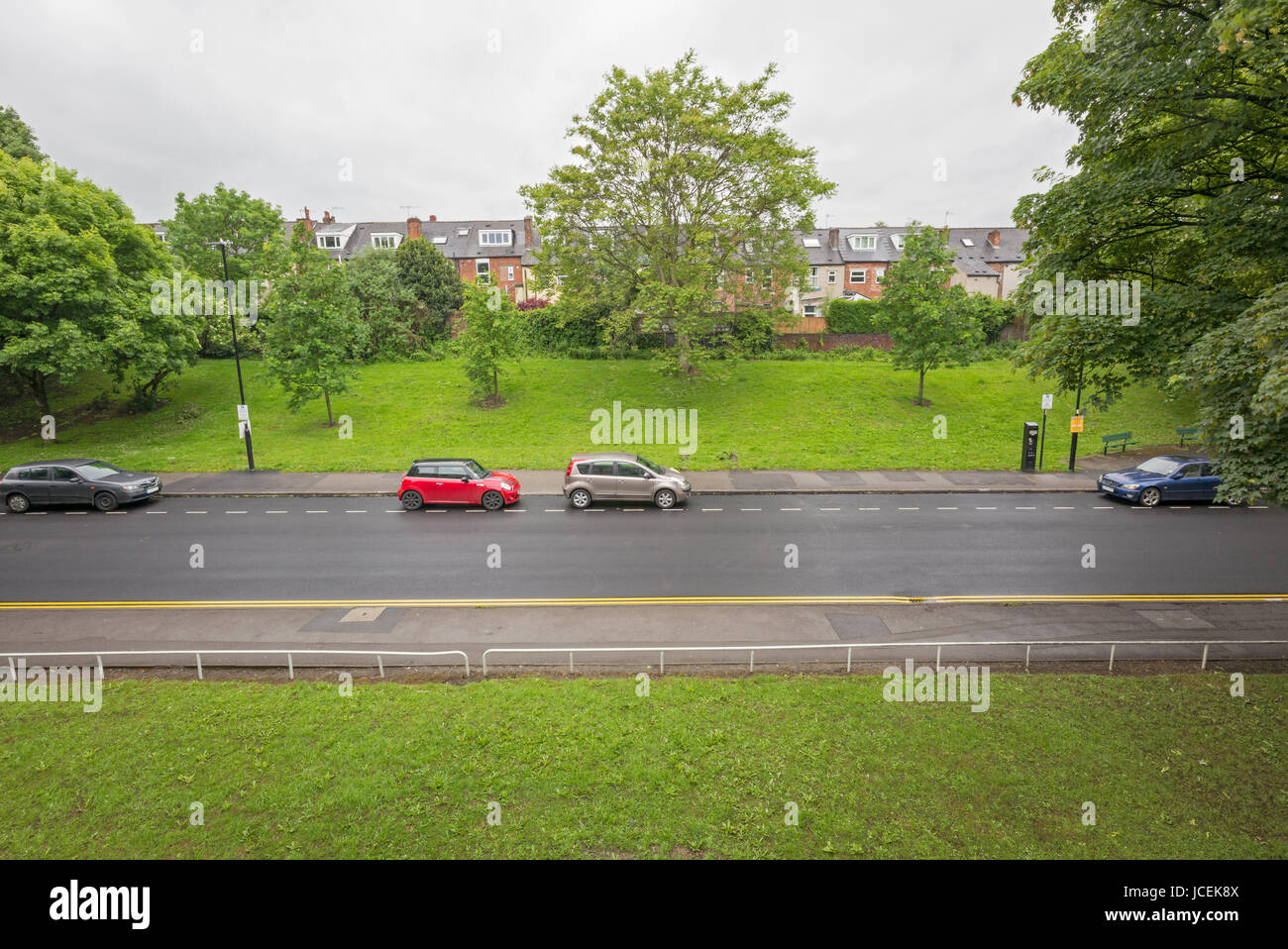 Cars parked in metered parking area on suburban road, Sheffield, UK