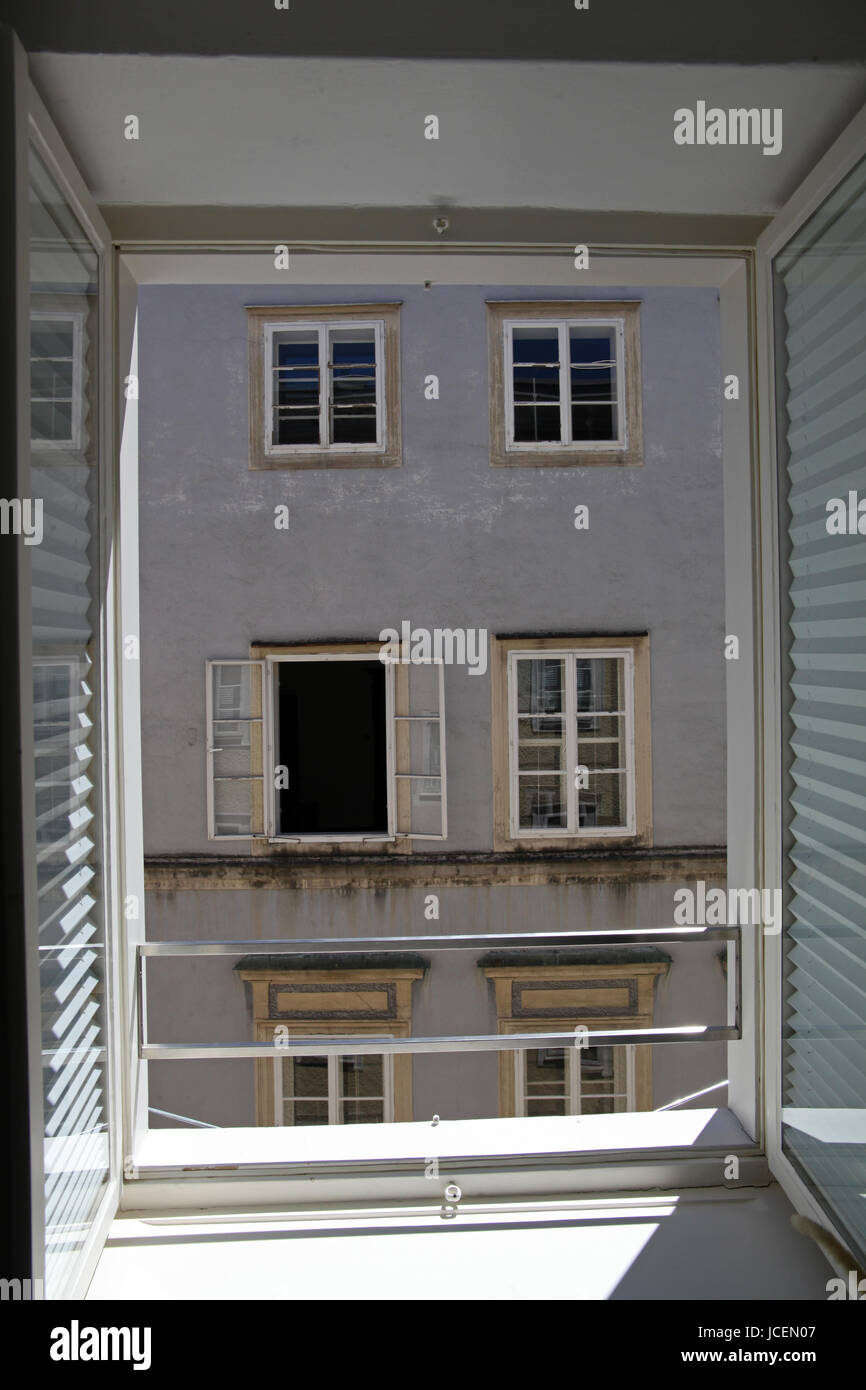 a picture window view from an apartment on Getreidegasse in Salzburg city centre Stock Photo