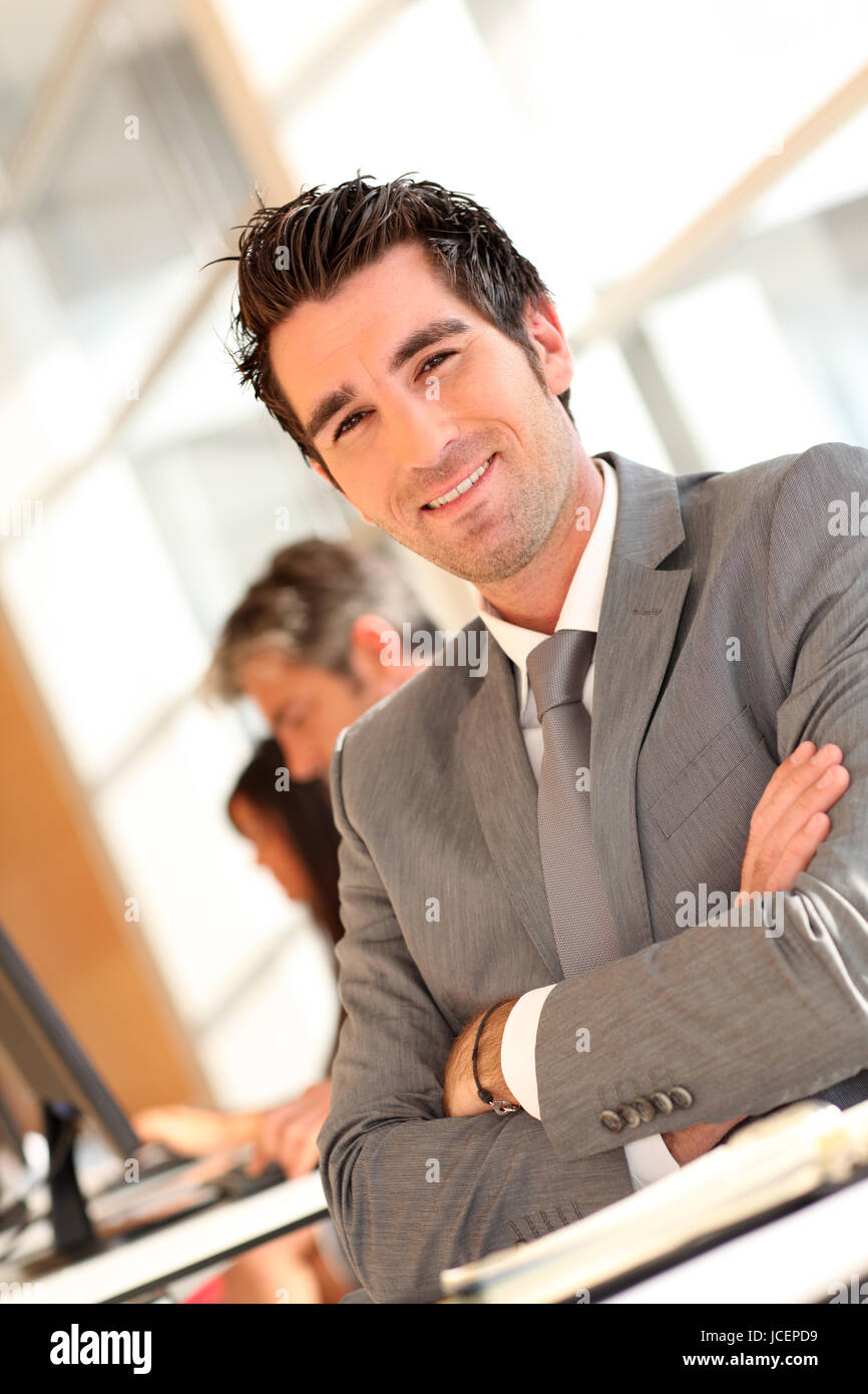 Portrait of smilng businessman with arms crossed Stock Photo - Alamy