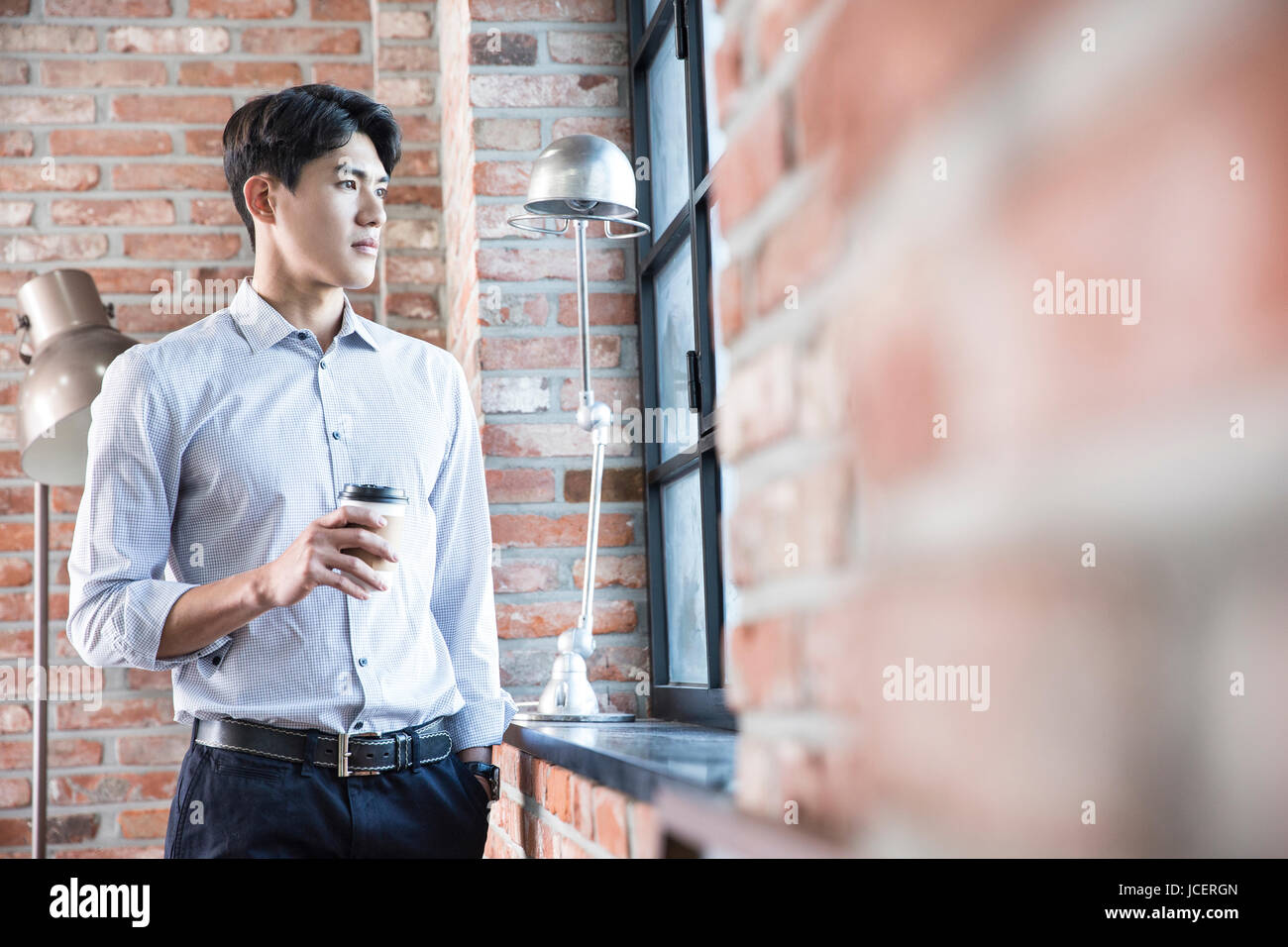 Male architect with takeout coffee at office Stock Photo Alamy